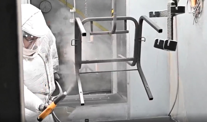 Employee Spraying Metal Chair Frame