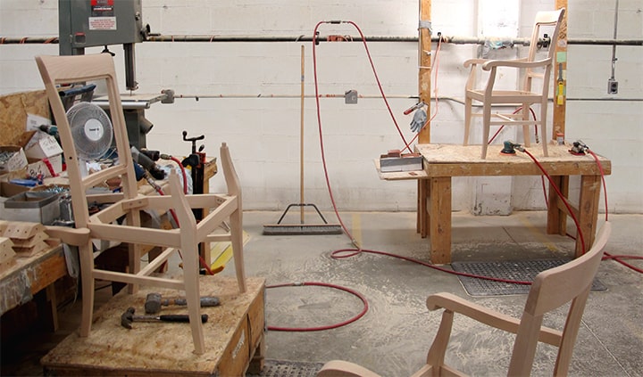Wooden chair frames in a small manufacturing space