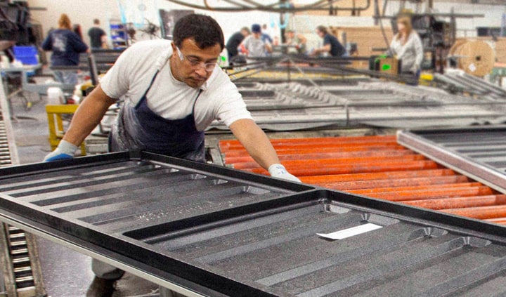 Employee moving a table in the manufacturing process