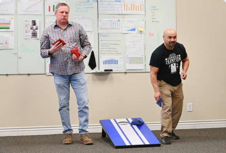 Two Employees At Cornhole Competition